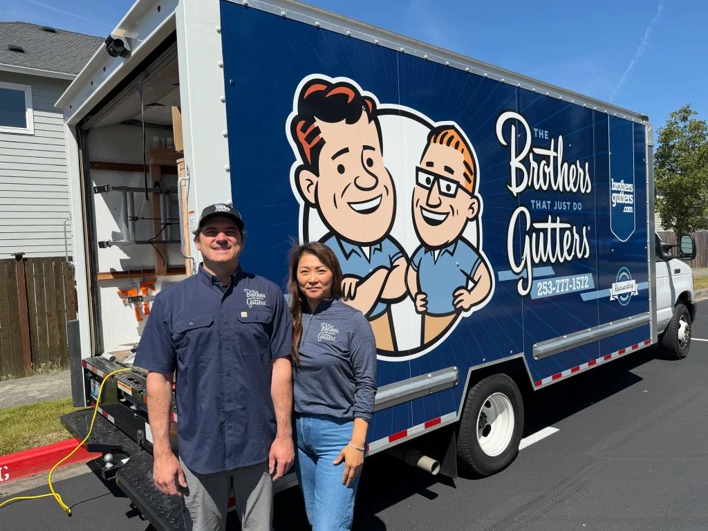 Jamie and Zeke Edwards with the Brothers Gutters truck at a South Sound job