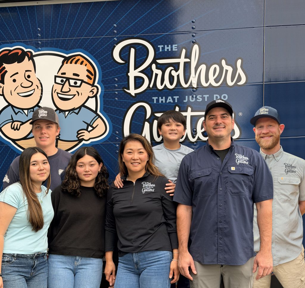 The Tacoma Brothers Gutters team and family in front of the company truck