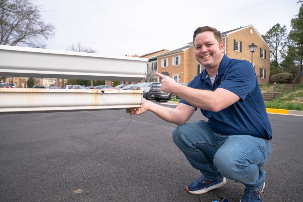 A Solutionist holding a new seamless gutter section